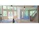 Open living space with hardwood floors, staircase, fireplace, and lots of natural light at 4515 Aiden Way, Cumming, GA 30041