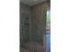 Shower featuring marble-look tile walls, glass door and niche at 4515 Aiden Way, Cumming, GA 30041
