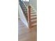 Elegant staircase featuring hardwood steps and contrasting white risers and trim at 4515 Aiden Way, Cumming, GA 30041