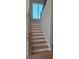 Bright staircase features hardwood steps with white risers and trim, leading to upper level with natural light at 4515 Aiden Way, Cumming, GA 30041