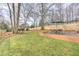 Backyard featuring a lush lawn, patio with outdoor seating, garden beds, and privacy fence at 389 Kendrick Se Ave, Atlanta, GA 30315