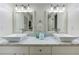 Bathroom with a white marble countertop, white cabinets, double sinks, and stylish lighting fixtures at 389 Kendrick Se Ave, Atlanta, GA 30315