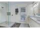 Beautiful bathroom featuring a glass door shower, white cabinets and a marble countertop with double sinks at 389 Kendrick Se Ave, Atlanta, GA 30315