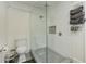 Bathroom featuring a glass shower, toilet, and white cabinets and walls at 389 Kendrick Se Ave, Atlanta, GA 30315