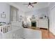 Bright bedroom featuring a white crib, fireplace, a white dresser and wood flooring at 389 Kendrick Se Ave, Atlanta, GA 30315