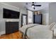 Charming bedroom featuring a ceiling fan, black wardrobe, and a large dresser with hardwood flooring at 389 Kendrick Se Ave, Atlanta, GA 30315