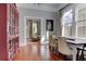 Bright dining room with large windows, wood floors, and a view into the cozy living room at 389 Kendrick Se Ave, Atlanta, GA 30315
