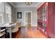Bright dining room with large windows, hardwood floors, and a vintage red display cabinet at 389 Kendrick Se Ave, Atlanta, GA 30315