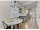 Stylish eat-in kitchen area boasting modern lighting, shiplap accents and hardwood flooring at 389 Kendrick Se Ave, Atlanta, GA 30315