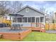 Back exterior featuring a screened-in porch, deck, patio, and gravel landscaping at 389 Kendrick Se Ave, Atlanta, GA 30315