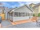 Back exterior featuring a screened-in porch, deck, patio, and gravel landscaping at 389 Kendrick Se Ave, Atlanta, GA 30315