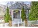 Charming home with an inviting front porch, American flag and manicured landscaping and a white picket fence at 389 Kendrick Se Ave, Atlanta, GA 30315