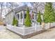 Charming home with an inviting front porch and well-maintained landscaping and a white picket fence at 389 Kendrick Se Ave, Atlanta, GA 30315