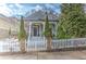 Charming home with stone accents, a quaint white picket fence and an inviting front porch with manicured landscaping at 389 Kendrick Se Ave, Atlanta, GA 30315