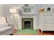 Bedroom fireplace featuring a white mantle with animal figurines and a comfortable chair at 389 Kendrick Se Ave, Atlanta, GA 30315