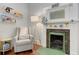 Bedroom fireplace featuring a white mantle with animal figurines, a comfortable chair, and book shelves at 389 Kendrick Se Ave, Atlanta, GA 30315