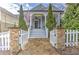 Charming home with stone accents, a quaint white picket fence and an inviting front porch with manicured landscaping at 389 Kendrick Se Ave, Atlanta, GA 30315