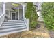 Inviting front porch with classic details, stone walkway, stylish lanterns, and well-maintained landscaping at 389 Kendrick Se Ave, Atlanta, GA 30315