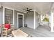 Inviting covered front porch with a ceiling fan, comfortable seating, and stylish gray wood flooring at 389 Kendrick Se Ave, Atlanta, GA 30315