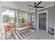Inviting covered front porch with a ceiling fan, comfortable seating, and stylish gray wood flooring at 389 Kendrick Se Ave, Atlanta, GA 30315