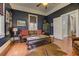 Stylish living room featuring dark blue walls, leather sofa, hardwood floors, and natural light at 389 Kendrick Se Ave, Atlanta, GA 30315