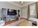 Bright living room features a modern TV console, hardwood floors, and a view of the front door at 389 Kendrick Se Ave, Atlanta, GA 30315