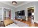 Stylish living room with hardwood floors, area rug, modern TV console, and doorways to other rooms at 389 Kendrick Se Ave, Atlanta, GA 30315