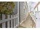 Narrow side yard with white picket fence and mature landscaping at 389 Kendrick Se Ave, Atlanta, GA 30315