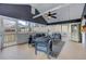 Comfortable screened porch featuring gray furniture, ceiling fan, and views of the fenced yard at 389 Kendrick Se Ave, Atlanta, GA 30315