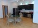 Modern kitchen with black cabinets and a glass dining table at 48 Moury Se Ave, Atlanta, GA 30315