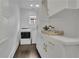 Clean laundry room with white cabinets and modern appliances at 115 17Th Street Ne, Atlanta, GA 30309