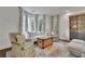 Bright living room features a bay window, comfortable seating, and an antique coffee table at 115 17Th Street Ne, Atlanta, GA 30309