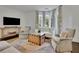 Bright living room with large windows, neutral furniture, and a decorative wood chest at 115 17Th Ne St, Atlanta, GA 30309