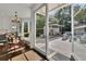 Bright dining area with large glass doors leading to outdoor living area with pool and mature landscaping at 115 17Th Ne St, Atlanta, GA 30309