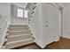 Bright staircase with white trim and carpeted steps leading to the upper level at 115 17Th Ne St, Atlanta, GA 30309