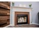 Modern fireplace with white mantel and rustic wood wall at 2322 Sheridan Ct, Villa Rica, GA 30180