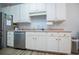 White kitchen with stainless steel appliances and light countertops at 2322 Sheridan Ct, Villa Rica, GA 30180