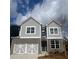 Charming two-story home with grey siding, brick accents, white trim, and a two-car garage at 269 Lakeside Pl, Canton, GA 30114