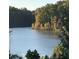 Scenic view of a lake surrounded by lush autumn foliage at 269 Lakeside Pl, Canton, GA 30114