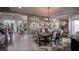 Elegant dining room with brick accent wall, decorative lighting, and neutral color palette at 11360 Bennett Ln, Johns Creek, GA 30097