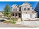 Brick two-story home with three-car garage and landscaped yard at 11360 Bennett Ln, Johns Creek, GA 30097