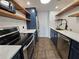 Modern kitchen with stainless steel appliances and blue cabinets at 1280 W Peachtree W St # 1407, Atlanta, GA 30309