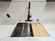 Modern kitchen sink with a black faucet and a cutting board at 1280 W Peachtree W St # 1407, Atlanta, GA 30309