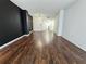 Spacious living room with dark accent wall and wood floors at 1280 W Peachtree W St # 1407, Atlanta, GA 30309
