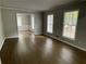 Spacious living room with hardwood floors, large windows, and an open floor plan at 2812 Arlington Rd, Atlanta, GA 30344