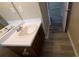 Clean bathroom with single vanity, sink, and tub at 6627 Coventry Pt, Austell, GA 30168
