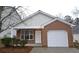 Brick and siding ranch home with a white garage door and small front porch at 6627 Coventry Pt, Austell, GA 30168