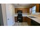 Well-equipped kitchen featuring wood cabinets, and modern appliances at 6627 Coventry Pt, Austell, GA 30168