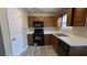 Well-equipped kitchen featuring wood cabinets, and modern appliances at 6627 Coventry Pt, Austell, GA 30168