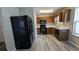 Kitchen with black appliances and wood cabinets at 6627 Coventry Pt, Austell, GA 30168